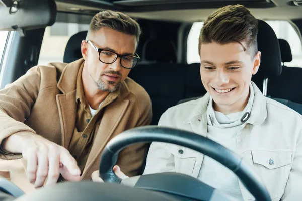 Friendly driving instructor with student